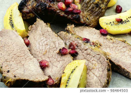 Veal meat baked with kiwi and pomegranate. Veal meat baked with kiwi and pomegranate. 98464503