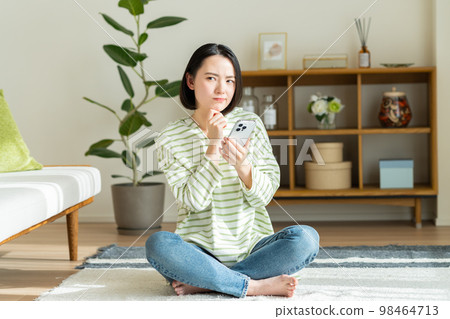 Young woman relaxing in the living room Young woman relaxing in the living room 98464713