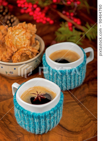 coffee with cardamom. winter drink. Coffee in cups with cardamom and white sugar on vintage wooden background coffee with cardamom. winter drink. Coffee in cups with cardamom and white sugar on vintage wooden background 98464760