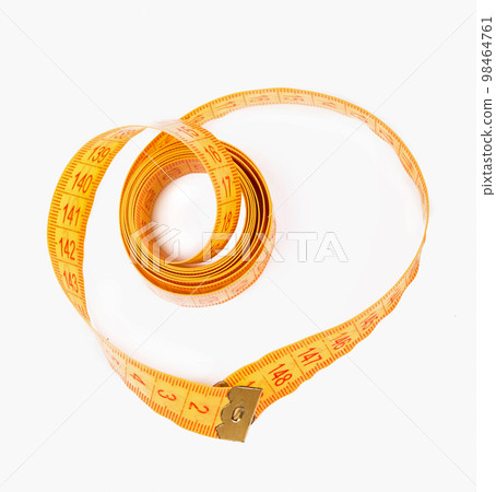 yellow measuring tape isolated on a white background yellow measuring tape isolated on a white background 98464761