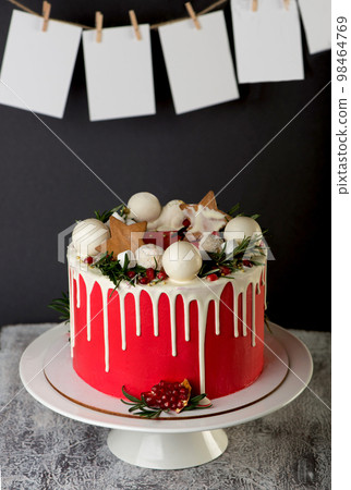 Festive Christmas cake on a rustic wooden stand and holiday decoration. New Year cards and sparklers 98464769