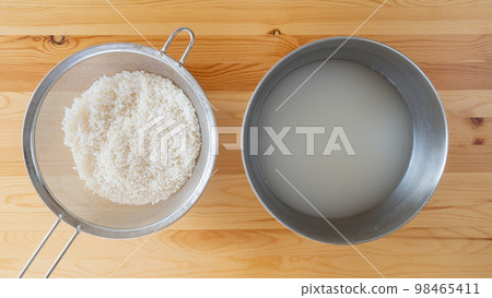 washed white rice and water washed white rice and water 98465411