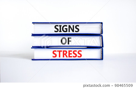 Signs of stress symbol. Concept words Signs of stress on books. Beautiful white table white background. Psychological business and signs of stress concept. Copy space. 98465509