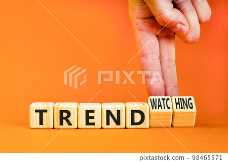 Trend or trendwatching symbol. Concept words Trend and trendwatching on wooden cubes. Businessman hand. Beautiful orange table orange background. Business trend or trendwatching concept. Copy space. Trend or trendwatching symbol. Concept words Trend and trendwatching on wooden cubes. Businessman hand. Beautiful orange table orange background. Business trend or trendwatching concept. Copy space. 98465571