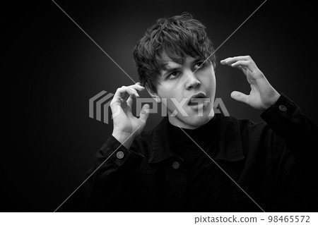 crazy young man with awesome hairdo grimacing crazy young man with awesome hairdo grimacing 98465572