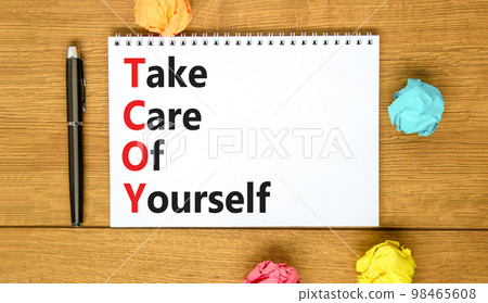 TCOY take care of yourself symbol. Concept words TCOY take care of yourself on white note on beautiful wooden background. Business TCOY take care of yourself concept. Copy space. TCOY take care of yourself symbol. Concept words TCOY take care of yourself on white note on beautiful wooden background. Business TCOY take care of yourself concept. Copy space. 98465608