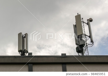 5G smart mobile phone radio network antenna base station on a telecommunications mast emitting a signal 5G smart mobile phone radio network antenna base station on a telecommunications mast emitting a signal 98465951