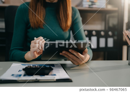 Female working with tablet and laptop and digital tablet computer. 98467065