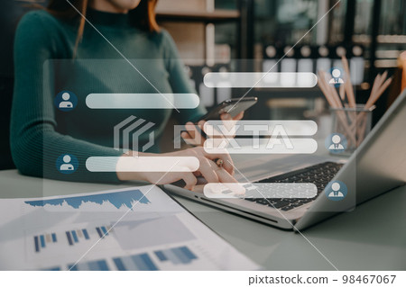 woman using mobile phone to chat with friends during free time. 98467067