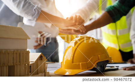Team architects workers, men and women, join hands to join forces to join forces to work for the industry for success. Team architects workers, men and women, join hands to join forces to join forces to work for the industry for success. 98467072