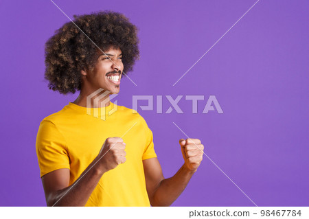 Happy african man celebrating raising the fists 98467784