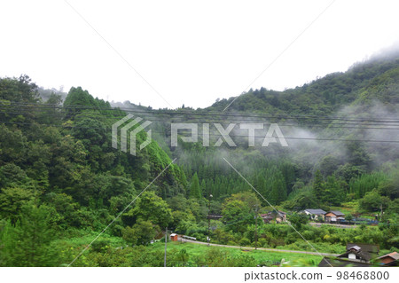 A rainy morning in the summer of 2022, scenery from the train window from Saiki Station to Nobeoka Station on the Nippo Main Line A rainy morning in the summer of 2022, scenery from the train window from Saiki Station to Nobeoka Station on the Nippo Main Line 98468800