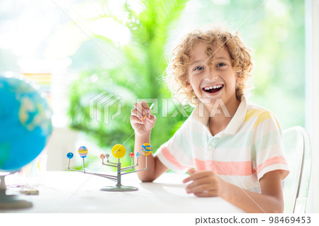Child with solar system model. Kids planetarium. Child with solar system model. Kids planetarium. 98469453