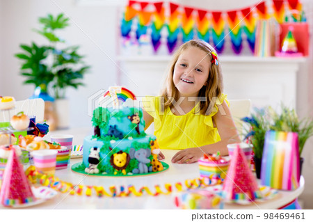 Child birthday party. Kids blow candle on cake. Child birthday party. Kids blow candle on cake. 98469461