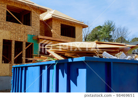 As part of construction site waste removal process metal container used for recycling garbage trash dumpster is used 98469651