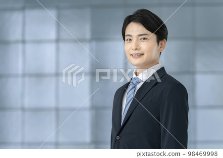 A young man in a suit looking at the camera portrait A young man in a suit looking at the camera portrait 98469998