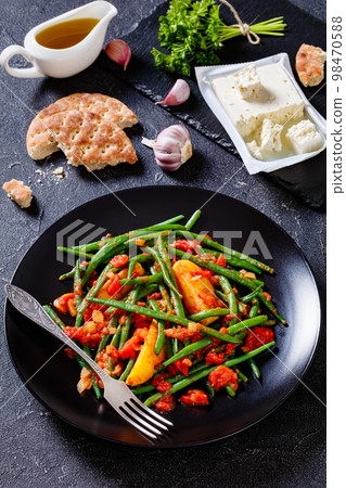 fasolakia, green beans, tomatoes and potatoes stew 98470588