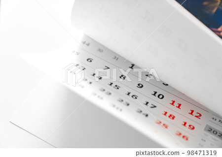 flipping through the pages of the flip calendar. flipping through the pages of the flip calendar. 98471319