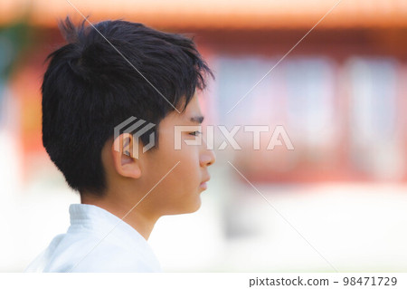 Side profile of a boy in a uniform 98471729