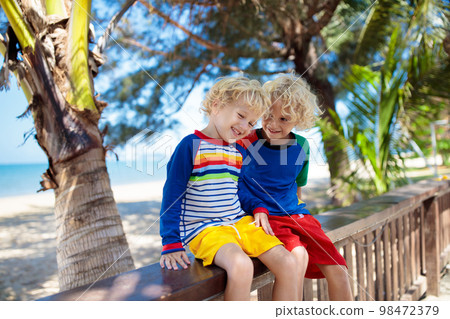 Kids at tropical beach. Child on summer vacation. 98472379