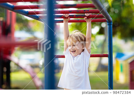 Child on playground. Kids play outdoor. 98472384