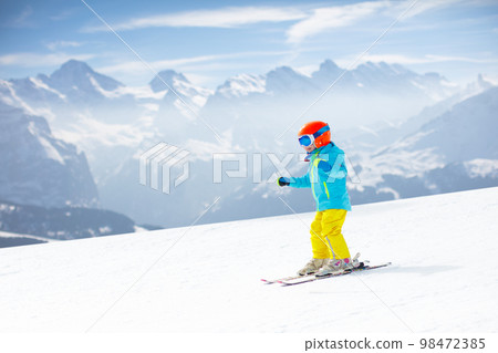 Kids winter snow sport. Children ski. Family skiing. 98472385