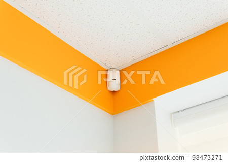 Combined motion or glass break sensor detector for security system mounted on wall in a hospital or house.  98473271