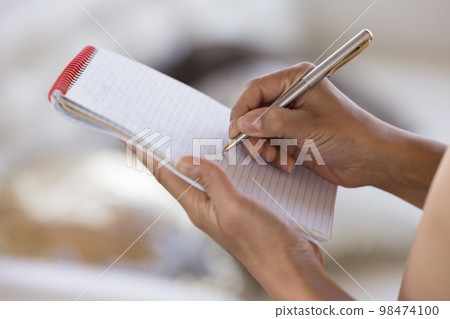 Woman writing on paper, using copybook, pen, making draft Woman writing on paper, using copybook, pen, making draft 98474100