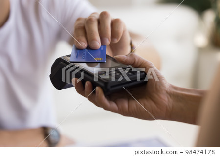 Customer man making payment for service, purchase, cashless technology Customer man making payment for service, purchase, cashless technology 98474178