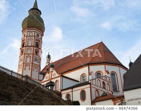 Andechs, Germany - December 27th 2022: Front of the baroque monastery church under the blue sky Andechs, Germany - December 27th 2022: Front of the baroque monastery church under the blue sky 98474366