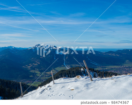 Lengries, Germany - December 28th 2022: Panoramic view towards Brauneck, Bavarian mountain on a sunny winter day Lengries, Germany - December 28th 2022: Panoramic view towards Brauneck, Bavarian mountain on a sunny winter day 98474367