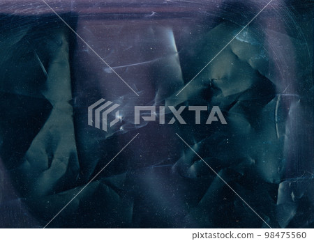 Scratched film texture. Dust noise overlay. Creased worn layer for photo editor. Blue purple color light flare grain on dark wrinkled distressed abstract background. Scratched film texture. Dust noise overlay. Creased worn layer for photo editor. Blue purple color light flare grain on dark wrinkled distressed abstract background. 98475560