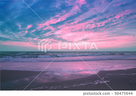 Seascape in the evening. Sunset over the sea with the beautiful cloudy blazing sky 98475644