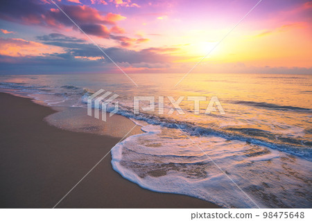 Seascape in the evening. Sunset over the sea with the beautiful blazing sky Seascape in the evening. Sunset over the sea with the beautiful blazing sky 98475648