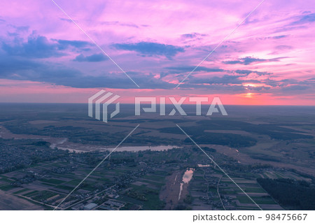Beautiful sunset in the countryside in spring with the blazing sky. Aerial view  98475667