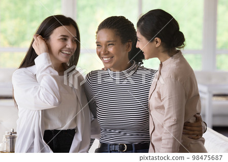 Joyful positive diverse female best friends meeting and hugging 98475687