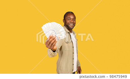 Cheerful middle aged african american male in casual show a lot of money cash, recommend investment 98475949