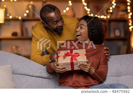 Handsome african american man greeting his beloved wife girlfriend Handsome african american man greeting his beloved wife girlfriend 98475982