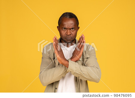 Angry confident sad middle aged african american man in casual crossed arms, doing stop sign 98476095