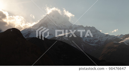 Mount Kazbek in the evening. Georgian mountain landscape Mount Kazbek in the evening. Georgian mountain landscape 98476647