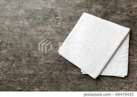 Top view of white towels with copy space on colored background Top view of white towels with copy space on colored background 98479435