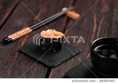 Gunkan Maki Sushi of fish salmon, scallop, perch, eel, shrimp and caviar on wooden table background. Sushi menu. Japanese food sushi set gunkans Gunkan Maki Sushi of fish salmon, scallop, perch, eel, shrimp and caviar on wooden table background. Sushi menu. Japanese food sushi set gunkans 98480463