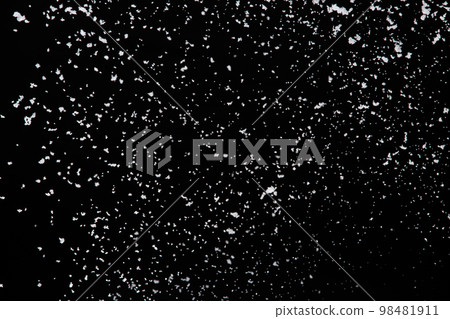 Photo image of falling down snow, heavy big small size snows. Freeze shot on black background isolated overlay. Fluffy White snowflakes splash cloud in mid air. Real Snow high speed shutter 98481911