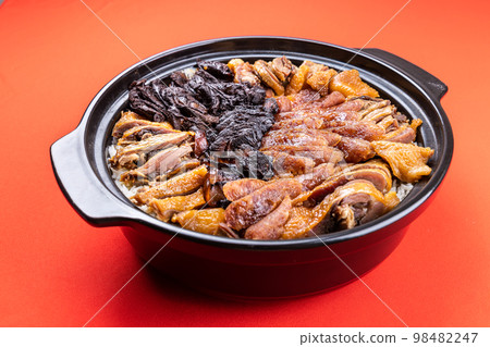 Lap mei fan or waxed meat rice with red on red background. It is Chinese traditional dish that is served during Chinese New Year festive Lap mei fan or waxed meat rice with red on red background. It is Chinese traditional dish that is served during Chinese New Year festive 98482247