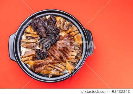 Overhead view of Lap Mei Fan or waxed meat rice with red on red background. It is Chinese traditional dish that is served during Chinese New Year festive 98482248