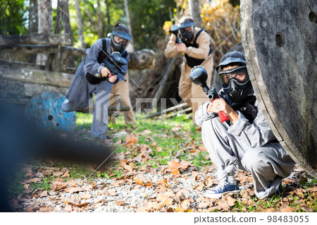 People in full gear playing paintball People in full gear playing paintball 98483055