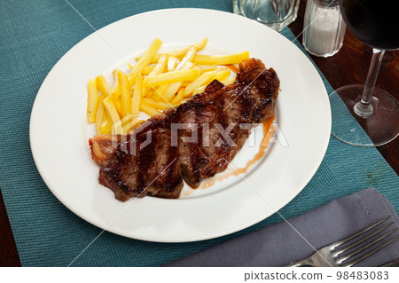 Delicious grilled beef with french fries at the plate 98483083