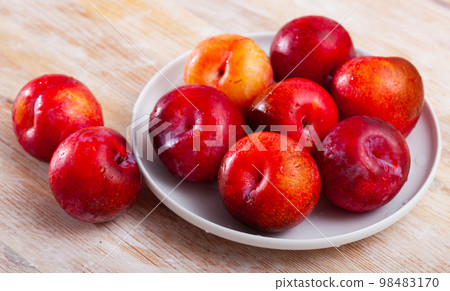 Fresh red plums in plate Fresh red plums in plate 98483170