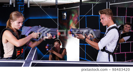Two laser tag teams playing indoors Two laser tag teams playing indoors 98483420