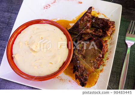 Beef stew served with mashed potatoes at plate 98483445